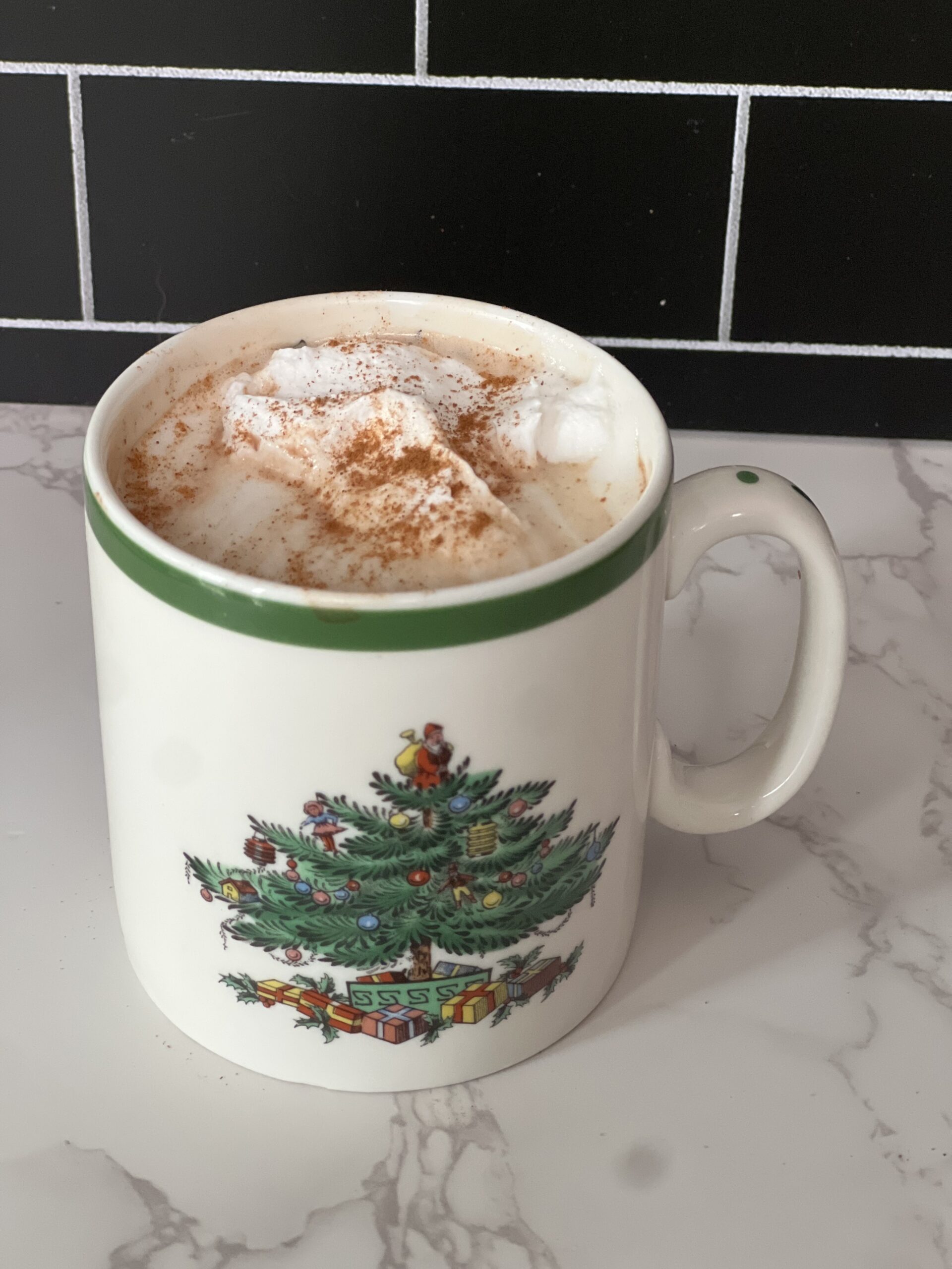 bone broth hot chocolate with whipped cream on top in a mug on a counter